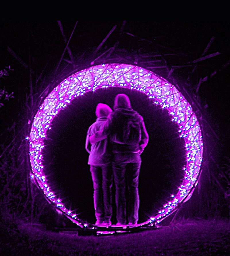 Two people standing inside a lighted purple circle