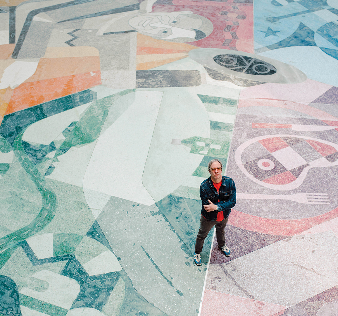 artist matt goad standing on color floor mosaic at Will Rogers World Airport