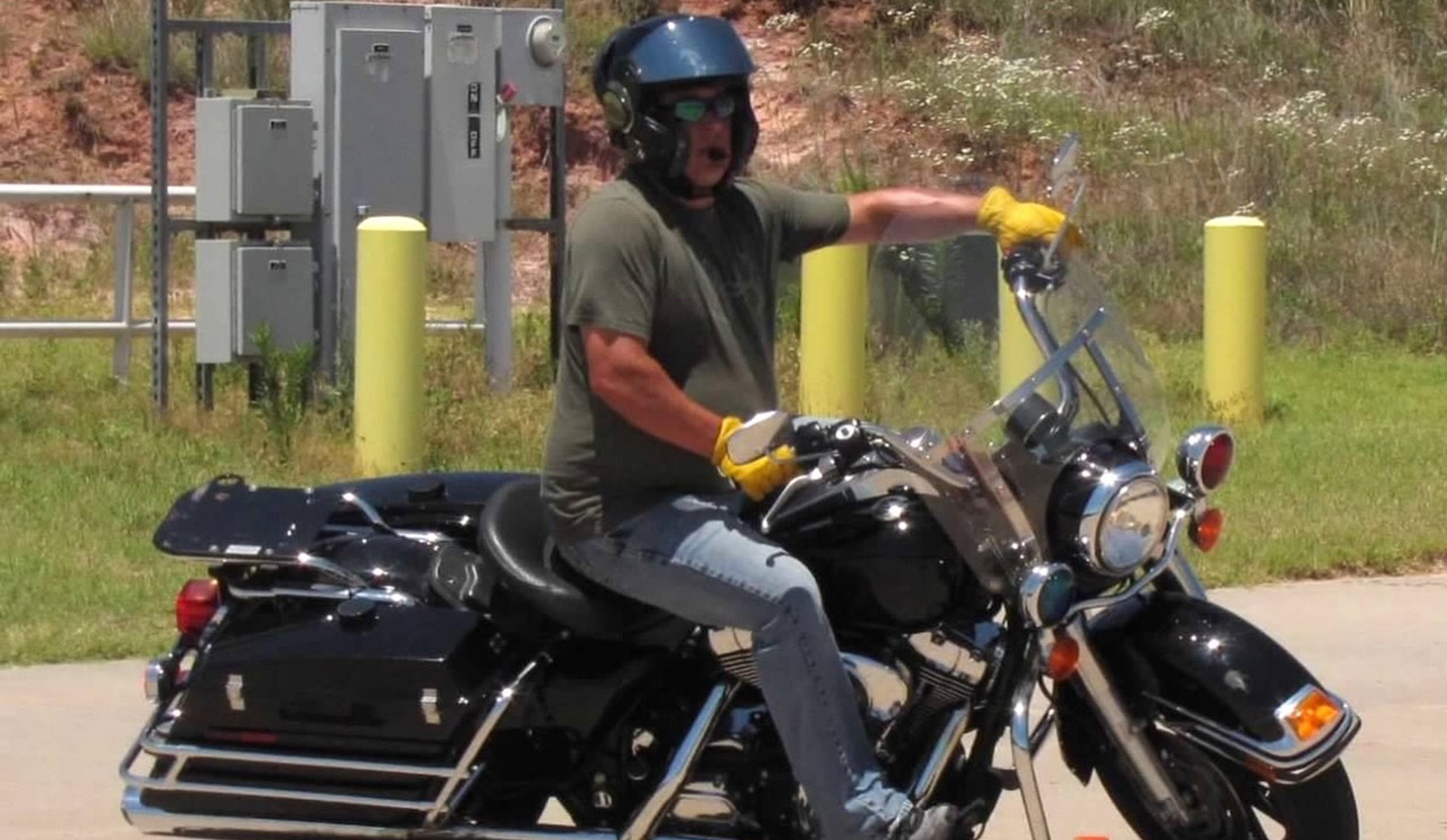 man on motorcycle turning around cones