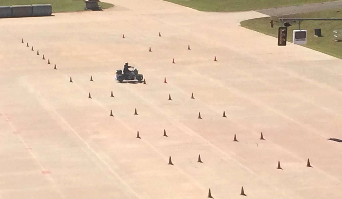 motorcyclist driving cone course