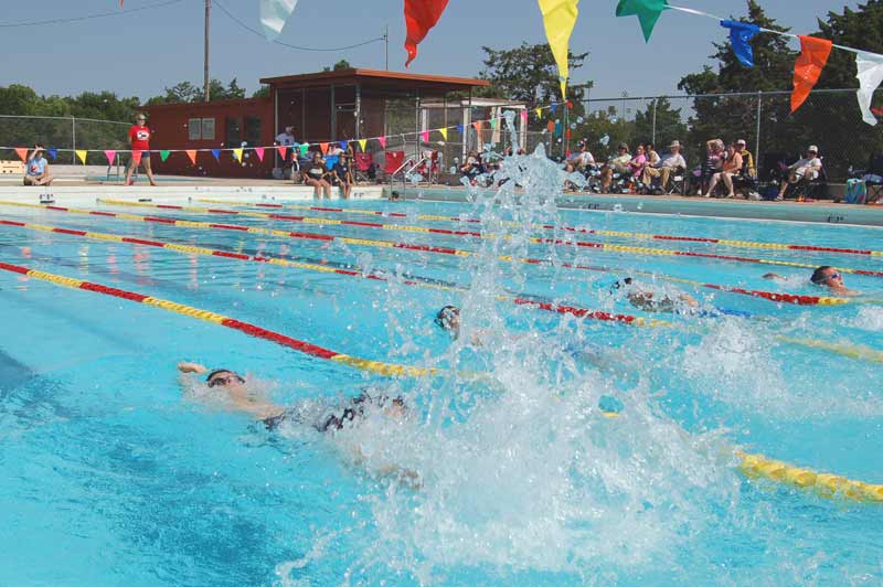 Swimmers participate in a swim meet at the Will Rogers Aquatic Center