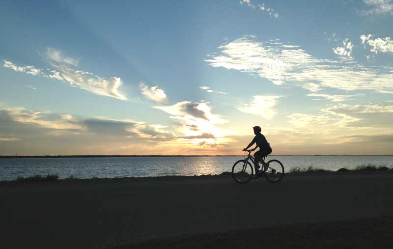 Residents enjoy the sunset views at Lake Hefner on the Burt Cooper Trails